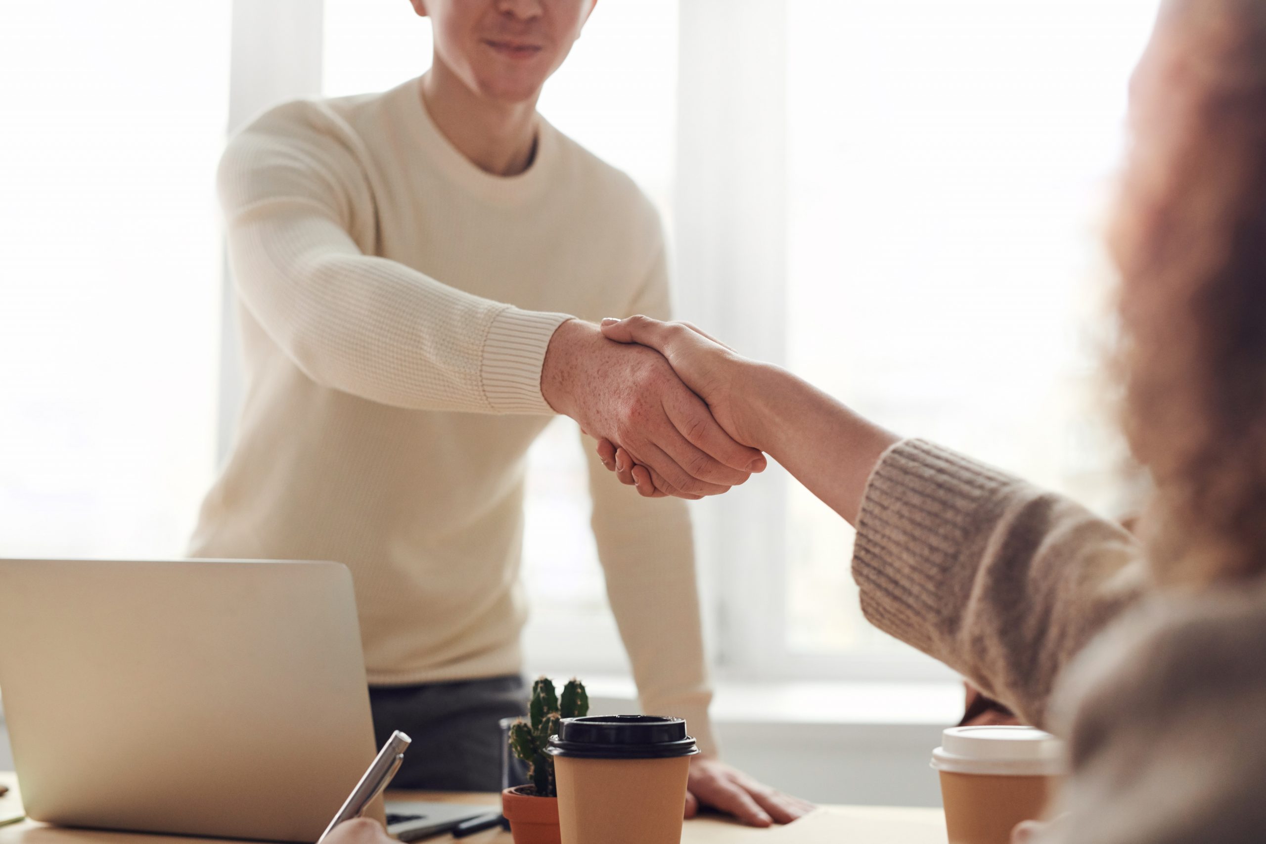 A man shaking a woman's hand in a business deal