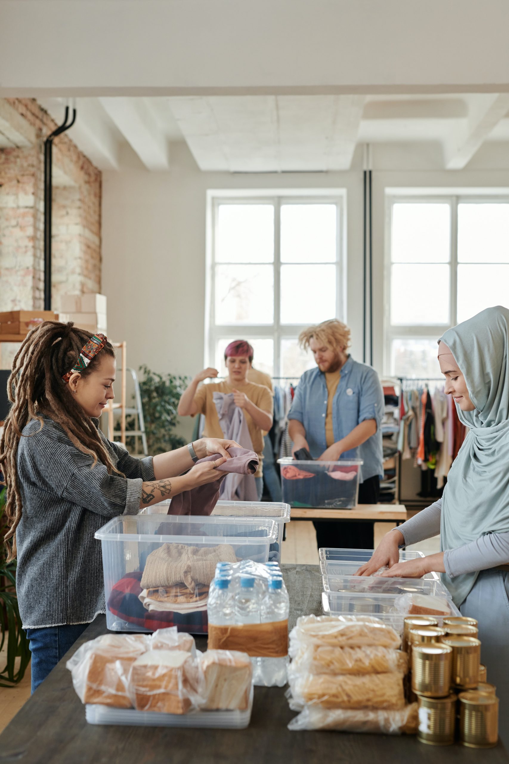 Food bank workers preparing food and clothing for visitors