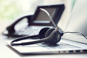 Headset headphones telephone and laptop in call center headphones, telephone and laptop in call centre representing how we helped a customer