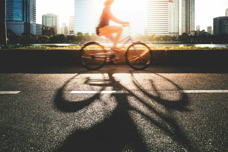 Woman riding a bike near a river