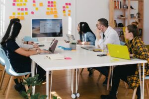 Employees at work discussing workplace culture Employees at work discussing workplace culture