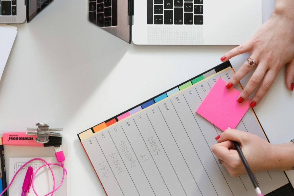 Woman planning with sticky notes and planner