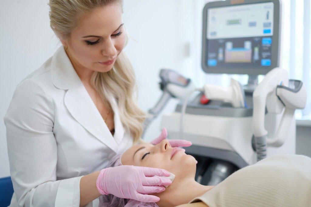 Woman getting treatment with aesthetic dermatology device.