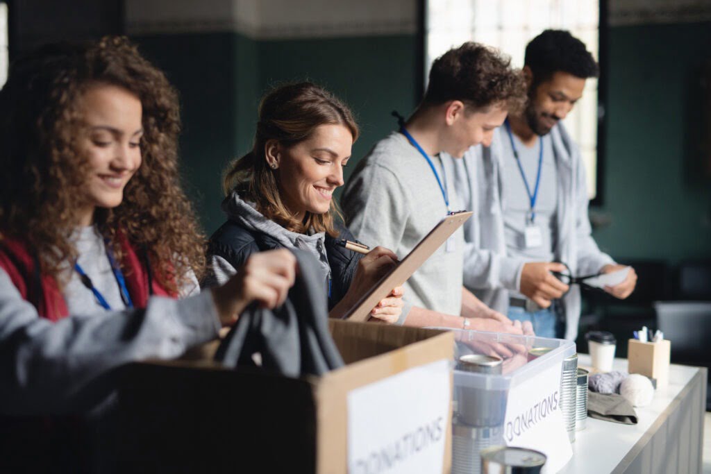 A group of volunteers working in community charity donation center.