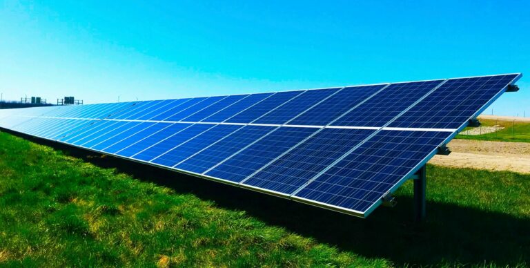 Solar panels in a sunny field.