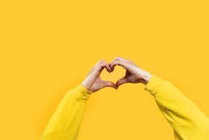 Hands making heart shape isolated on a yellow background – Love Hands making heart shape isolated on a yellow background