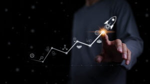 Startup business and investment concept. Businessman is touching the growing business graph. Planning and starting corporate business start up, Rocket icon soars with speed to hit the growth target. Startup business and investment concept. Businessman is touching the growing business graph. Planning and starting corporate business start up, Rocket icon soars with speed to hit the growth target.