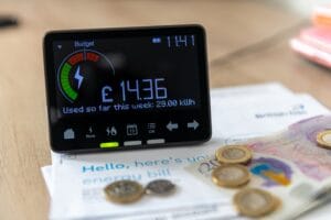A smart energy meter on household energy bills. Cost of living, rising energy cost concept.A smart energy meter on household energy bills. Cost of living, rising energy cost concept. smart meter at home representing ofgem energy price cap increase