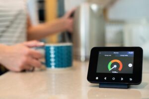 AdobeStock_299735794 Woman At Home Boiling Kettle For Hot Drink With Smart Energy Meter In Foreground representing smart metering changes