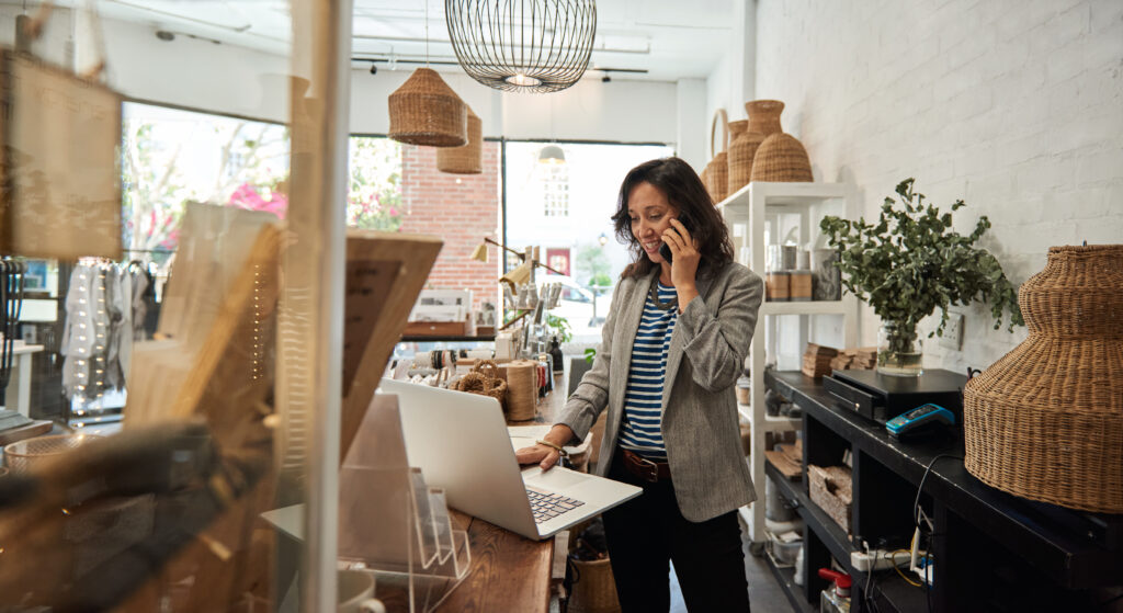 lady behind counter of retail store on phone