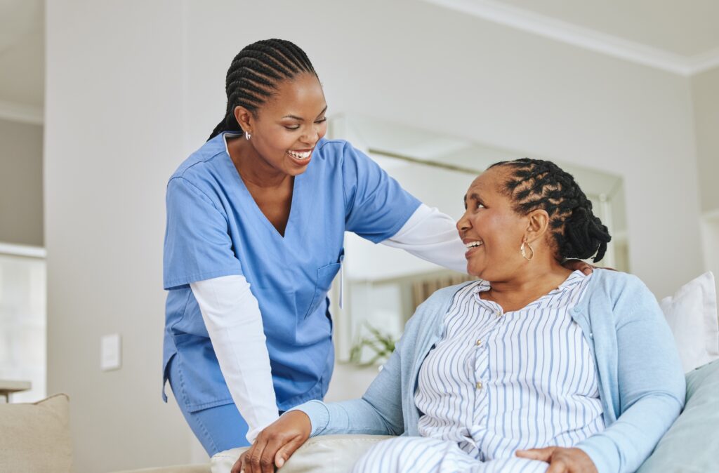 AdobeStock_609027881 Nurse and caregiver talking for support, healthcare and happiness at retirement home.