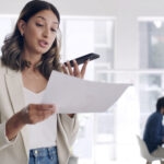 woman on loudspeaker holding contract for auto-renew