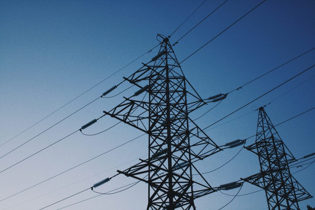 dmitriy-zarivniy-N5okH8Hd3OM-unsplash pylons against dark sky representing energy for smes