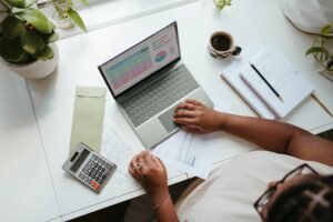 microsoft-365-oUbzU87d1Gc-unsplash lady researching suppliers on laptop using calculator to decide
