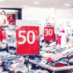 How Retailers Can Prepare for Black Friday 1 busy shop with red sale signs representing black friday
