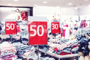 busy shop with red sale signs representing black friday